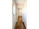Hallway view to bathroom featuring bathtub and oval window allowing natural light at 3723 Verde Glen Ln, Cumming, GA 30040