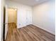 Bright bedroom with wood-look floors, closet and white door that offers ample space at 3723 Verde Glen Ln, Cumming, GA 30040