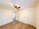 Neutral bedroom with wood floors, white door, and ceiling fan at 3723 Verde Glen Ln, Cumming, GA 30040