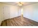 Bedroom with hardwood floors, ceiling fan, and closet with an opened door at 3723 Verde Glen Ln, Cumming, GA 30040