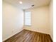 Cozy bedroom with wood floors and a window offering natural light at 3723 Verde Glen Ln, Cumming, GA 30040