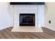 Close-up of a traditional white fireplace with a black mantel and wood flooring at 3723 Verde Glen Ln, Cumming, GA 30040