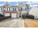 Charming townhouse with two-car garage, manicured landscaping, and inviting front entrance at 3723 Verde Glen Ln, Cumming, GA 30040