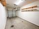 Spacious garage with a working door and organized wooden shelving for efficient storage at 3723 Verde Glen Ln, Cumming, GA 30040