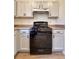 The kitchen has an appliance range, countertop space, and gray cabinets at 3723 Verde Glen Ln, Cumming, GA 30040
