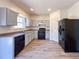 Modern kitchen boasts sleek countertops, black appliances, and ample cabinet space at 3723 Verde Glen Ln, Cumming, GA 30040