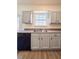 Close-up of the kitchen featuring grey cabinets, black appliances, sink and view to the outdoors at 3723 Verde Glen Ln, Cumming, GA 30040