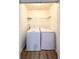 Cozy laundry room with white washer and dryer, and wire rack shelving at 3723 Verde Glen Ln, Cumming, GA 30040