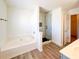Main bathroom with soaking tub, glass enclosed shower and stylish modern fixtures at 3723 Verde Glen Ln, Cumming, GA 30040