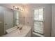 Bright bathroom featuring a double sink vanity, mirror, and a window offers an inviting space at 4486 Thorngate Ln, Acworth, GA 30101