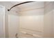 Clean and well-maintained bathtub with shower and wall-mounted storage offer relaxation and functionality at 4486 Thorngate Ln, Acworth, GA 30101