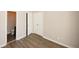 Neutral-toned bedroom with closet, wood flooring, and adjacent bathroom access offer comfort and convenience at 4486 Thorngate Ln, Acworth, GA 30101