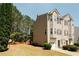 Charming exterior view of a townhome featuring neutral siding, green space, and an attached one-car garage at 4486 Thorngate Ln, Acworth, GA 30101