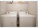 Functional laundry area features two machines with overhead storage shelf to organize the essentials at 4486 Thorngate Ln, Acworth, GA 30101