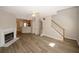 Open living area with hardwood floors, fireplace, kitchen view and a staircase at 4486 Thorngate Ln, Acworth, GA 30101