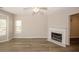Spacious living room with fireplace, ceiling fan, and attractive wood flooring at 4486 Thorngate Ln, Acworth, GA 30101