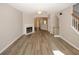 Open living room with fireplace, wood floors and view to staircase at 4486 Thorngate Ln, Acworth, GA 30101