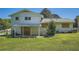 View of the back of the home with a fenced-in yard and covered patio at 6125 Dunbritan Ln, Atlanta, GA 30349