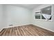 Bedroom features durable laminate flooring and a large window at 6125 Dunbritan Ln, Atlanta, GA 30349