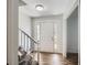 Bright foyer with a staircase and durable laminate flooring at 6125 Dunbritan Ln, Atlanta, GA 30349