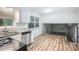 Bright kitchen boasts granite counters, stainless steel appliances, and wood-look floors to the living space at 6125 Dunbritan Ln, Atlanta, GA 30349
