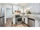 Kitchen with stainless steel appliances and durable laminate flooring at 6125 Dunbritan Ln, Atlanta, GA 30349