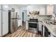 Kitchen with stainless steel appliances and durable laminate flooring at 6125 Dunbritan Ln, Atlanta, GA 30349