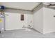 Utility room featuring a water heater, plumbing fixtures, and access panel at 6125 Dunbritan Ln, Atlanta, GA 30349