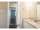 Modern bathroom featuring a granite vanity top, chrome faucet, and a mirrored wall at 7268 Westwood Ln, Douglasville, GA 30134