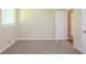 Bright bedroom with neutral carpet, large window, and white trim at 7268 Westwood Ln, Douglasville, GA 30134
