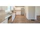 Well-lit kitchen boasts stainless appliances, pristine white cabinetry, and granite counters at 7268 Westwood Ln, Douglasville, GA 30134