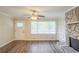 Bright living room with a stone fireplace, built-in shelves, and new flooring at 7268 Westwood Ln, Douglasville, GA 30134