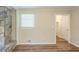 Open living space with a stone fireplace, new floors, and a doorway to another room at 7268 Westwood Ln, Douglasville, GA 30134