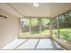 Bright sunroom with tile flooring and multiple windows offering backyard views at 7268 Westwood Ln, Douglasville, GA 30134