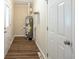 Functional utility room with water heater, shelving, and exterior access door at 7268 Westwood Ln, Douglasville, GA 30134