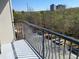 Private balcony overlooking a street with distant city views and mature trees at 901 Abernathy Ne Rd # 5050, Atlanta, GA 30328