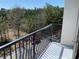 Apartment balcony overlooking trees and a street below provides natural light and space for enjoying the outdoors at 901 Abernathy Ne Rd # 5050, Atlanta, GA 30328