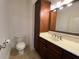 Well-lit bathroom with vanity, granite counters and cabinet for storage at 901 Abernathy Ne Rd # 5050, Atlanta, GA 30328