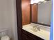 Bathroom features a dark wood vanity, large mirror with decorative frame, and ample counter space, exuding sophistication at 901 Abernathy Ne Rd # 5050, Atlanta, GA 30328