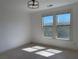 A bedroom with two windows and a modern ceiling light fixture at 901 Abernathy Ne Rd # 5050, Atlanta, GA 30328