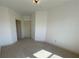 Spacious bedroom with neutral walls and carpet featuring two entry doors at 901 Abernathy Ne Rd # 5050, Atlanta, GA 30328