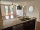 Open kitchen with granite countertops overlooking the living area and balcony doors at 901 Abernathy Ne Rd # 5050, Atlanta, GA 30328