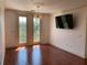 Bright living room featuring hardwood floors, balcony access, and modern chandelier at 901 Abernathy Ne Rd # 5050, Atlanta, GA 30328