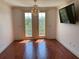 Bright living room with hardwood floors, balcony access, and a wall-mounted TV at 901 Abernathy Ne Rd # 5050, Atlanta, GA 30328