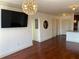 Bright living room with hardwood floors, tv, and modern lighting fixture at 901 Abernathy Ne Rd # 5050, Atlanta, GA 30328