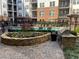 Well-kept pool area with a grill, a small flower bed, and brick-paved patio at 901 Abernathy Ne Rd # 5050, Atlanta, GA 30328