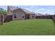 Expansive backyard featuring a well-maintained lawn, a covered patio, and secure fencing at 238 Dorothy Ln, Lawrenceville, GA 30046