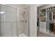 Tiled shower with glass door and walk-in closet with custom shelving at 238 Dorothy Ln, Lawrenceville, GA 30046