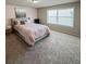 Comfortable bedroom with gray bed frame, carpeted floor, and a large window for plenty of natural light at 238 Dorothy Ln, Lawrenceville, GA 30046