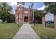 Historic Gwinnett Courthouse shows brick construction, well-maintained grounds, and informational signage for visitors at 238 Dorothy Ln, Lawrenceville, GA 30046